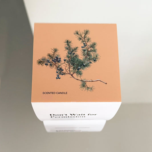 Juniper branch illustration on top of Unundone’s “Don’t Wait for Permission” candle packaging.