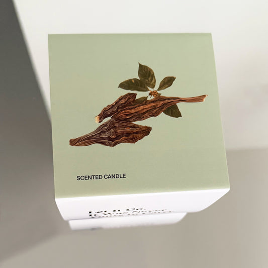 Top view of wood botanical drawing on Unundone’s “Let It Go” candle packaging.