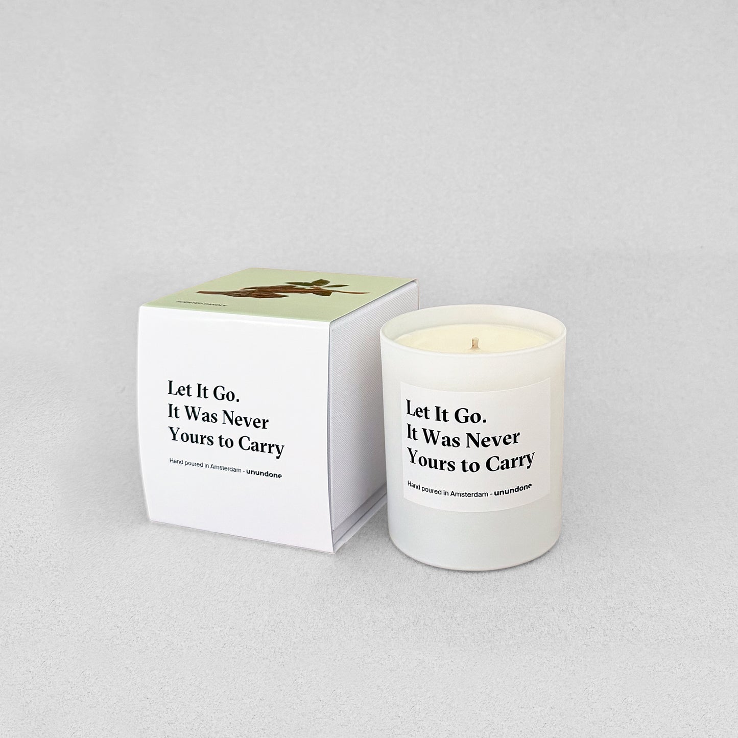 Unundone candle “Let It Go, It Was Never Yours to Carry” with wood illustration on box.