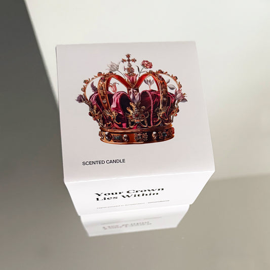Top view of Unundone’s candle box for ‘Your Crown Lies Within’, showing a floral crown illustration blending flowers and regal motifs.