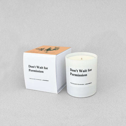 Affirmation candle “Don’t Wait for Permission” with illustrated box, shot on grey background.