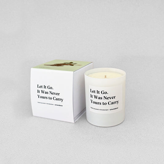 Unundone candle “Let It Go, It Was Never Yours to Carry” with wood illustration on box.
